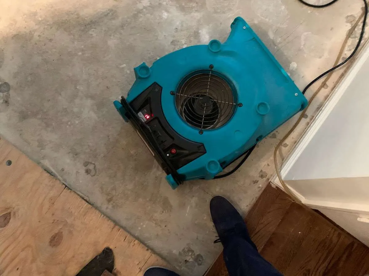 Air mover drying subfloor during Commercial Water Damage Restoration in Blackwell